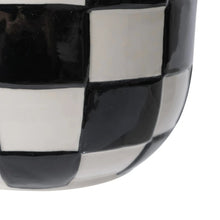 Ceramic planter close-up of glossy black-and-white checker tile pattern