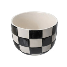 Round ceramic planter with glossy black-and-white checker pattern and white interior
