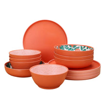 Orange bamboo melamine dinnerware set with stacked bowls and dinner plates