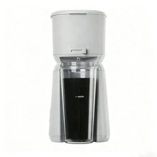Soft silver single-serve iced coffee maker with clear carafe and open lid