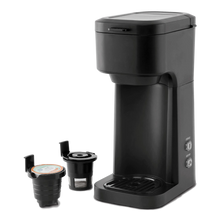 Black matte single-serve coffee maker with drip tray and pod holder, front view