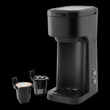 Black matte single-serve coffee maker with pod insert pieces and cup chamber shown