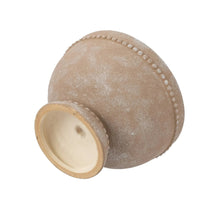 Cream ceramic plant pot with drainage hole at bottom and dotted side trim