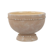 Cream ceramic pedestal plant pot with dotted rim detail and textured finish