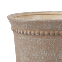 Ceramic urn planter pot, top rim close-up with beaded dot pattern, textured light beige