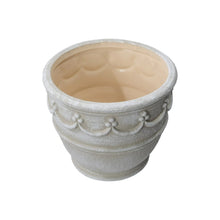 Cream ceramic planter with wave embossing and scalloped trim, open top
