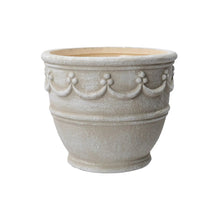 Cream ceramic planter with wave embossing and scalloped rim detail