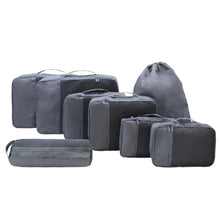 Gray packing cube set with stacked cubes and drawstring pouch, various sizes