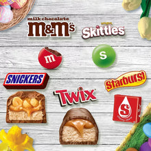 Assorted Easter candy minis on wood surface: M&M’s, Skittles, Snickers, Twix and Starburst