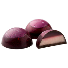 Purple chocolate bonbons with one halved piece showing a lighter purple filling