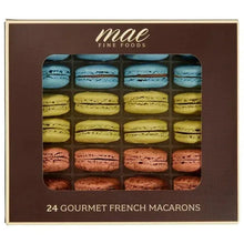 Boxed French macarons selection with blue, yellow, and pink macarons in window