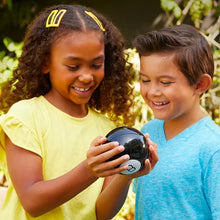 Magic 8 Ball held by two smiling children