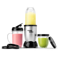 Single-serve blender with stainless base and black lids; yellow smoothie in blending cup.