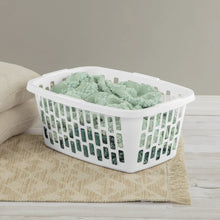White rectangular laundry basket filled with mint green folded towels