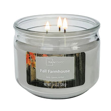 Lit scented 3-wick candle in clear glass jar with Fall Farmhouse label