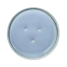 Blue candle wax surface in glass jar lid, circular view