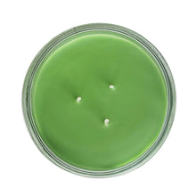 Top view of green wax jar candle in clear glass container