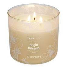 Glass jar scented candle with Bright Hibiscus label, three wicks and flame