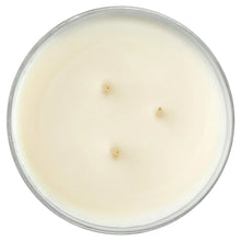 Top view of pale wax candle with three wick openings