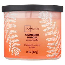 Scented candle jar with cranberry-mimosa label, black lid, orange-pink gradient