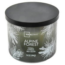 Scented candle jar with black lid, pine leaf wrap and Alpine Forest label, 14 oz