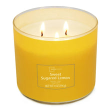 Lit 3-wick candle in yellow jar with three flames above wax top