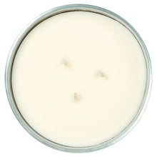 Unlit white wax candle in clear glass jar top view