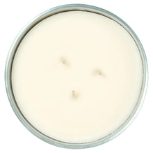 Candle in clear glass jar with pale wax top, three wick