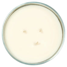 Unlit light wax candle in clear glass jar, three wicks visible