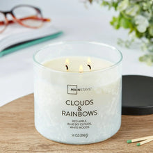 Lit scented jar candle with three flames and Clouds & Rainbows label