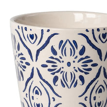 Round ceramic planter with close-up blue medallion floral pattern on off-white