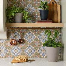 Beige self-watering resin planter with green plant on shelf