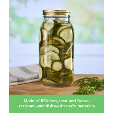 Wide-mouth glass mason jar with gold lid, filled with cucumber slices