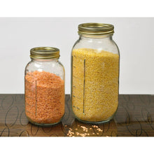 Wide-mouth glass jars with gold lids, filled with grains and legumes
