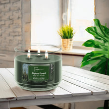 Green 3-wick scented candle in clear glass jar, Alpine Forest label, three wicks lit