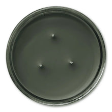 Dark green candle wax surface with three wick holes
