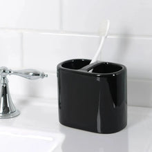 Black ceramic toothbrush holder with two slots for adult toothbrushes