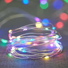 Multicolor LED wire lights coiled on wire, glowing in many colors