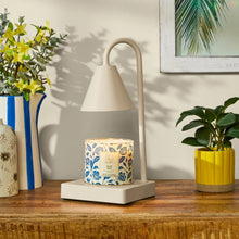 Beige candle warmer lamp on square base with conical shade and curved stand