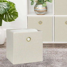 Beige fabric storage cube bin with gold grommet handle, square folded design