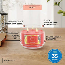 Mainstays cranberry mandarin 3-wick candle in a clear glass jar with red wax