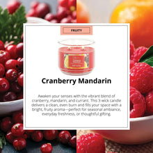 Mainstays cranberry mandarin scented candle in a clear glass jar with red wax