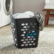 Black square laundry hamper with cutout sides and carry handles, open top.