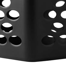 Black laundry hamper side panel with oval ventilation cutouts.
