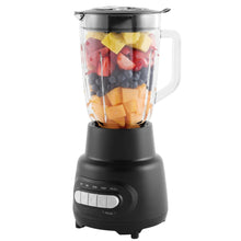 Glass jar blender with black base and clear jar filled with mixed ingredients