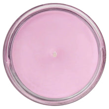 Top view of lilac pink wax candle inside clear glass jar