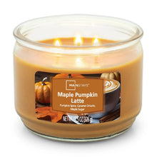 Lit glass jar candle with amber wax and Maple Pumpkin Latte label, three centered flames