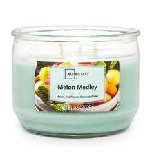 Candle jar with teal wax, three wicks, and Melon Medley scent label