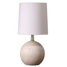 Mini table lamp with light fabric shade and textured ball base with brass stem