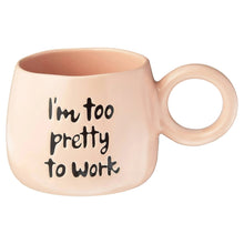 Light peach ceramic mug with “I'm too pretty to work” text and curved handle